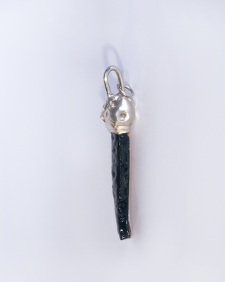 Pendant made of an elongated black glazed ceramic piece with a silver cap, the glaze "Fat Lava" looks like the surface of the moon