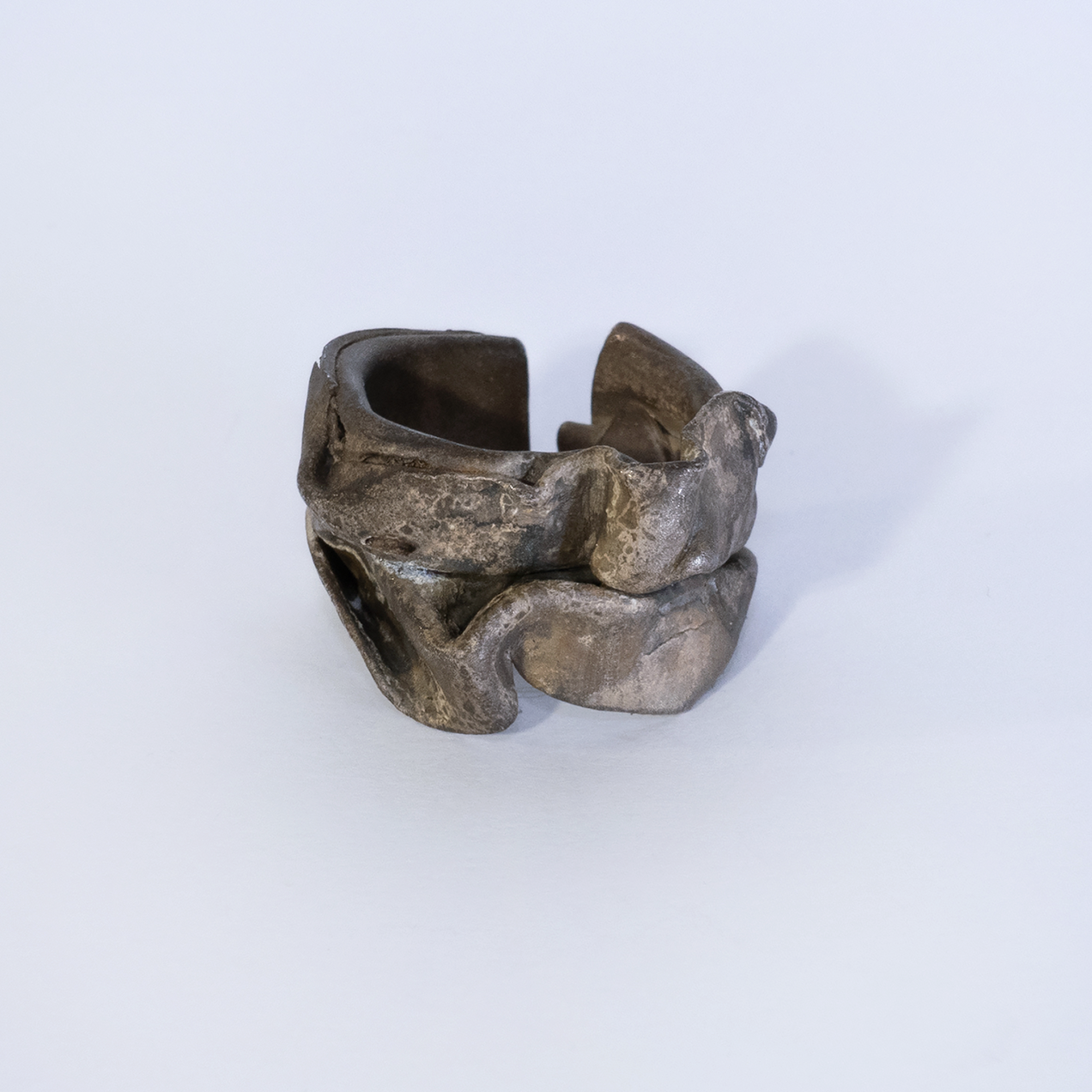 "Havy Foil" Curved open silver ring with brownish patina that looks like a thick crushed foil