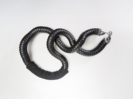 Heavy chain in black flexible industrial hose with cast silver clasps and silk fabric
