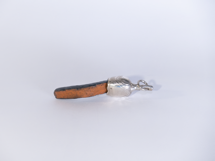 Pendant made of an elongated black glazed ceramic piece with a silver cap, the glaze "Fat Lava" looks like the surface of the moon