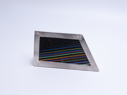 Irregular angular brooch with a silver frame and canvas in colourful fine stripes, it looks like a framed picture