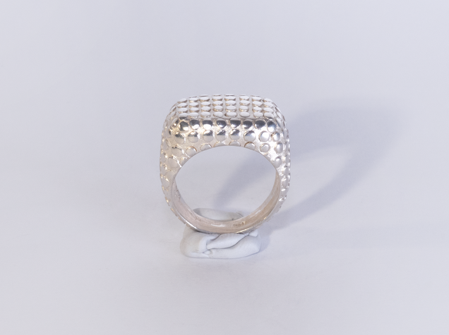 Wide heavy silver ring with polished flat nubs surface