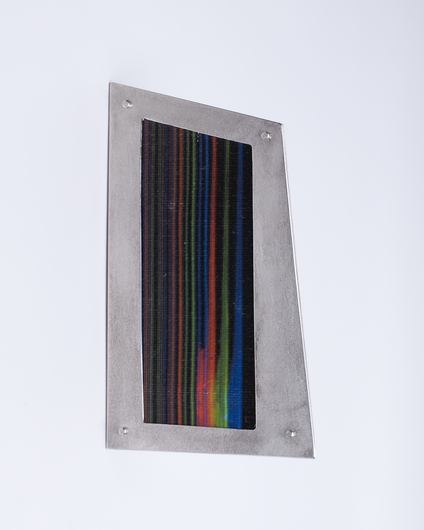 Irregular angular brooch with a silver frame and canvas in colourful fine stripes, it looks like a framed picture