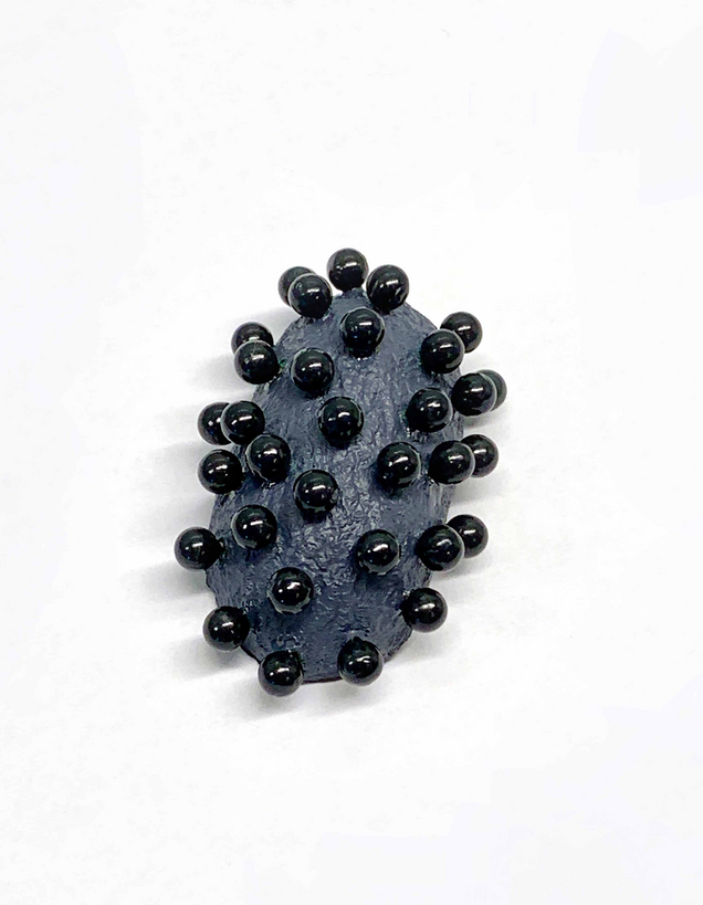 Open silver silk cocoon, pierced with many flat black pins, on a black silver chain