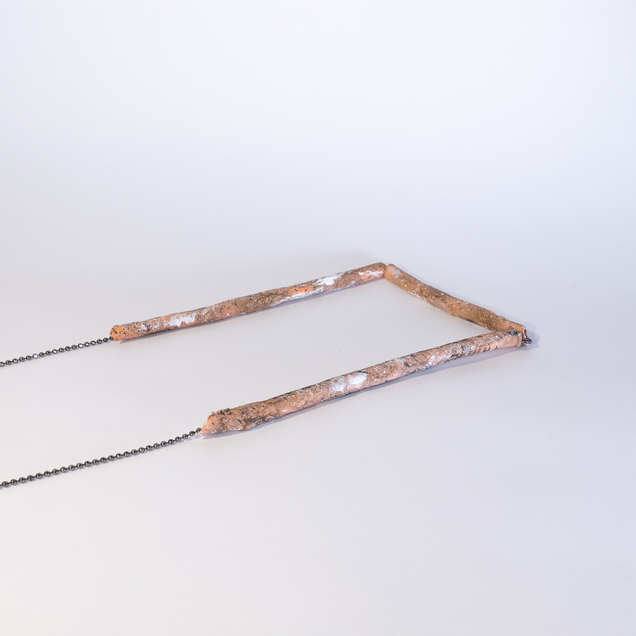 Black silver necklace with three tubes that look like osage twigs