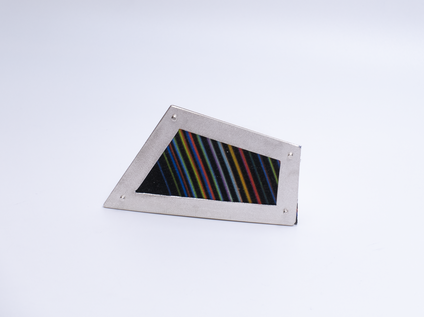 Irregular angular brooch with a silver frame and canvas in colourful fine stripes, it looks like a framed picture